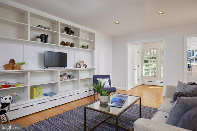 a living room with furniture and book shelf