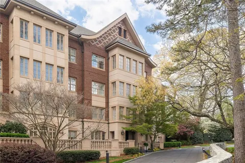 a front view of a residential apartment building with a yard