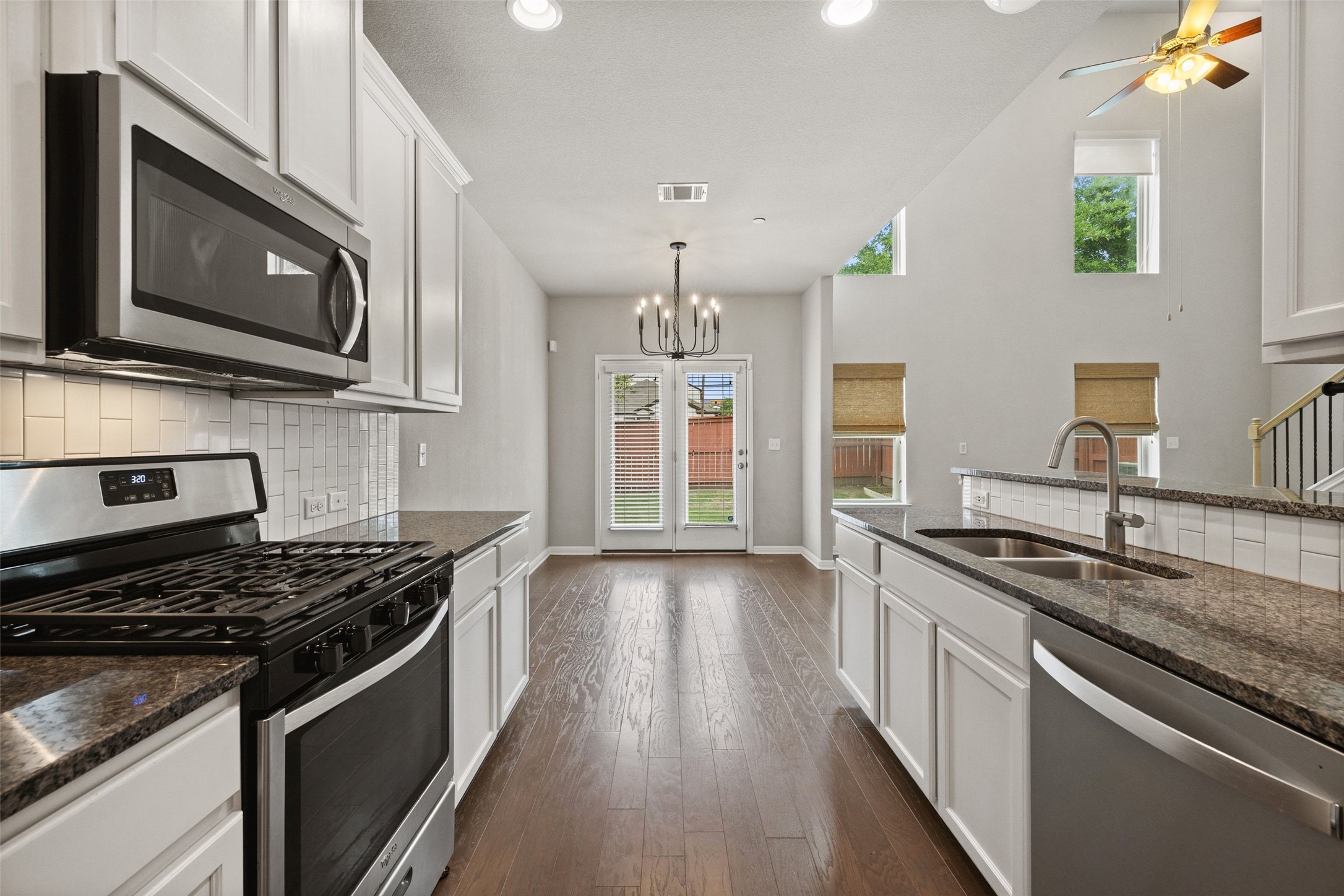 1615 Airedale Road Austin, TX 78748 - Photo 20 of 39 a kitchen with stainless steel appliances granite countertop a stove and a microwave