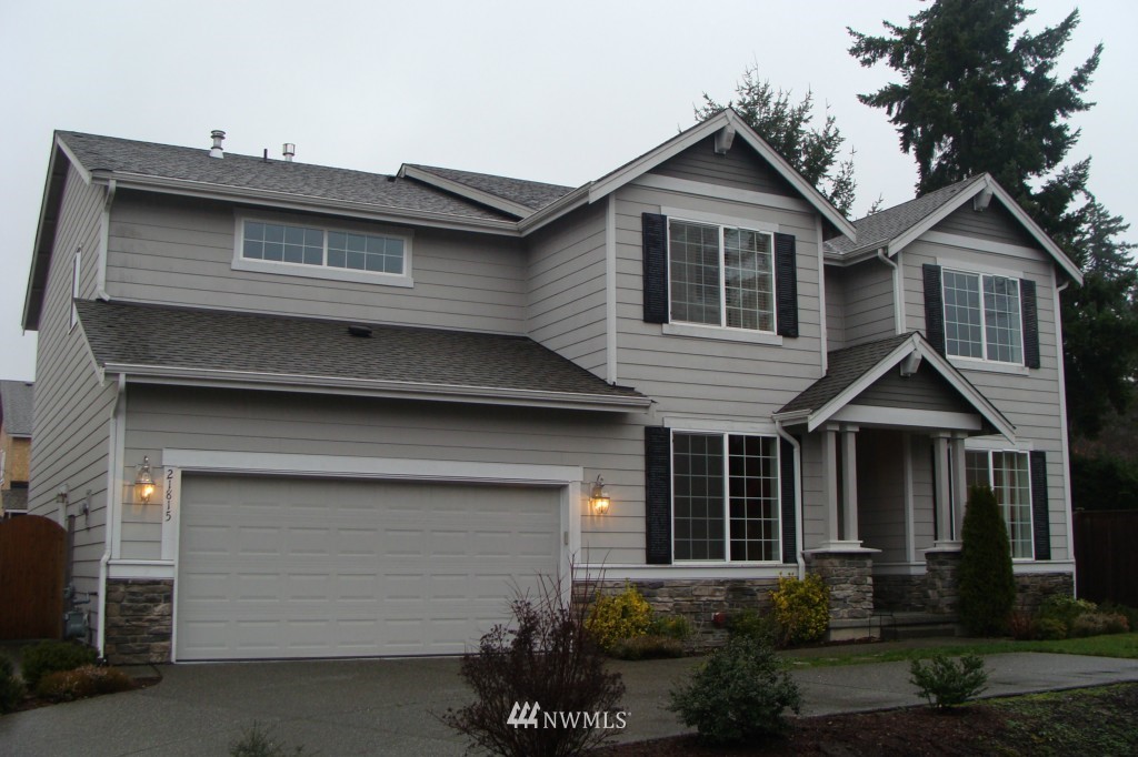 21815 39th Drive Southeast Bothell, WA 98021 - Photo 1 of 1 a front view of a house with a yard and garage