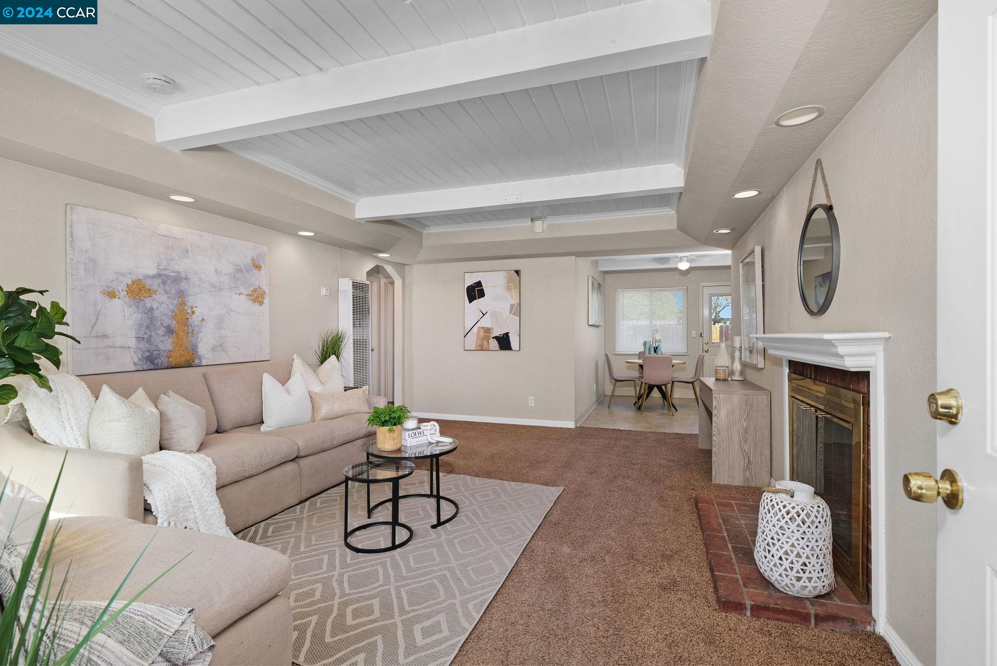 a living room with furniture a fireplace and a table