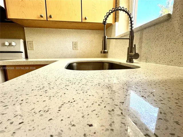 a kitchen with a sink and a window