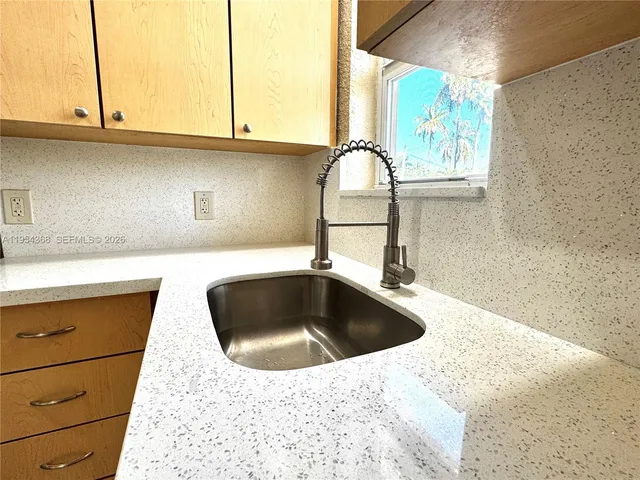a kitchen with a white stove top oven and refrigerator