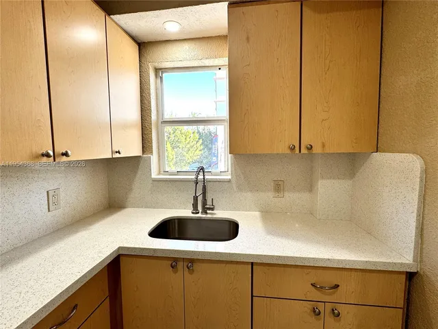 a bathroom with a shower and a sink