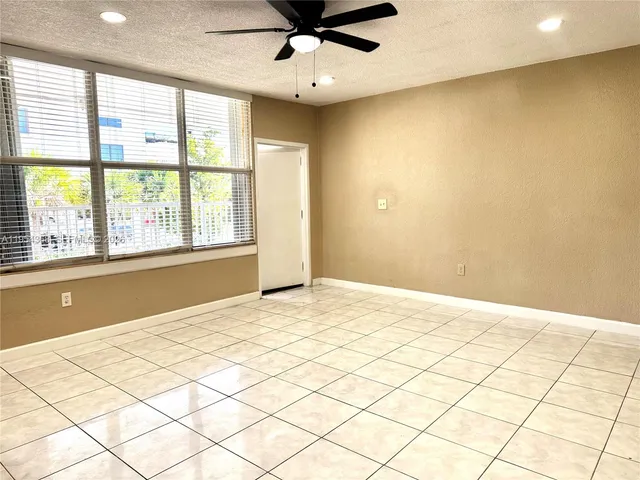a kitchen with a appliances a sink cabinets and a large window
