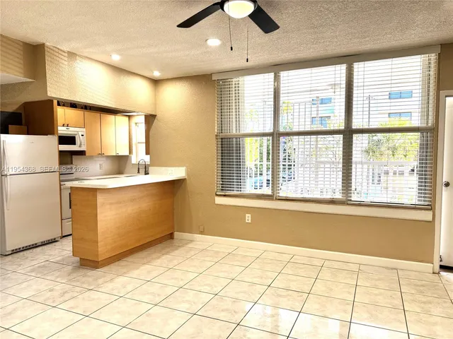 a kitchen with stainless steel appliances a refrigerator sink and cabinets