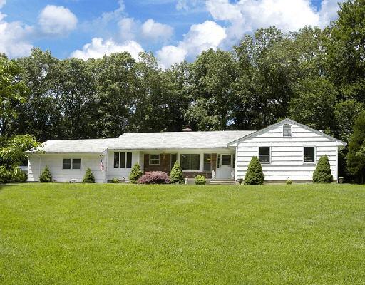 105 Old Logging Road Stamford, CT 06903 - Photo 1 of 1 a view of a house with a big yard
