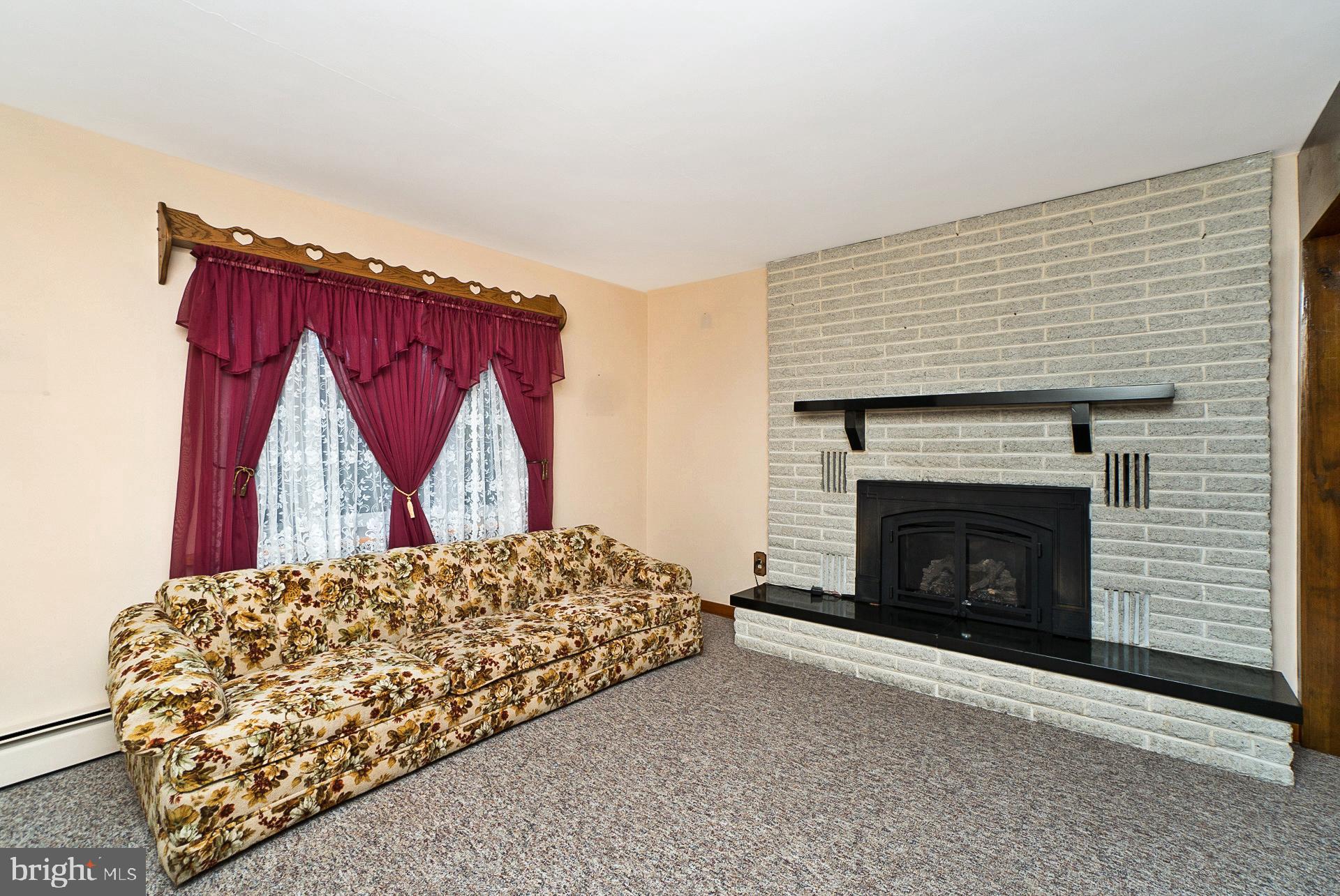 2627 Welshtown Road Slatington, PA 18080 - Photo 14 of 32 a living room with a couch fireplace and a fireplace