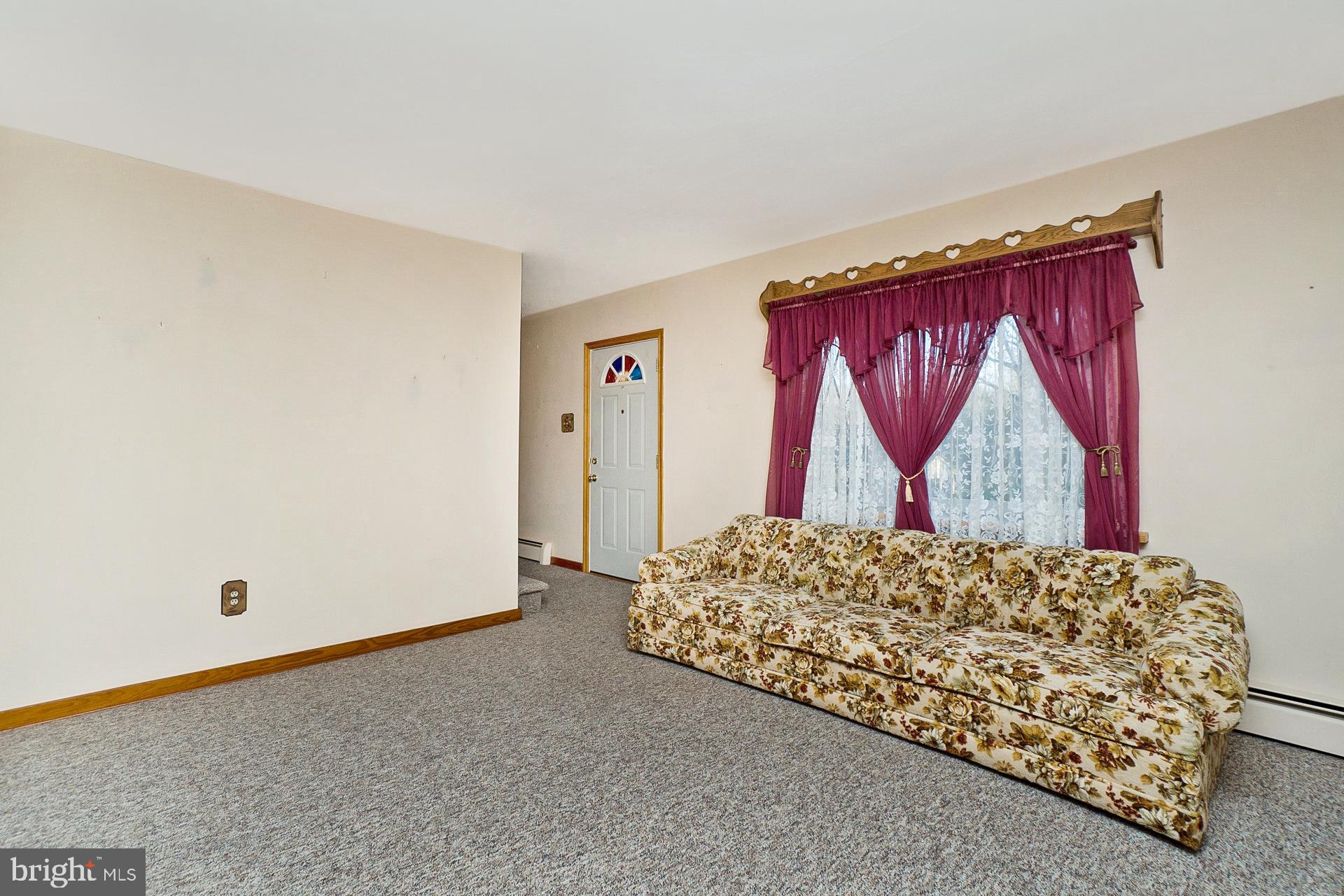 2627 Welshtown Road Slatington, PA 18080 - Photo 15 of 32 a living room with a bed and a dresser next to a window