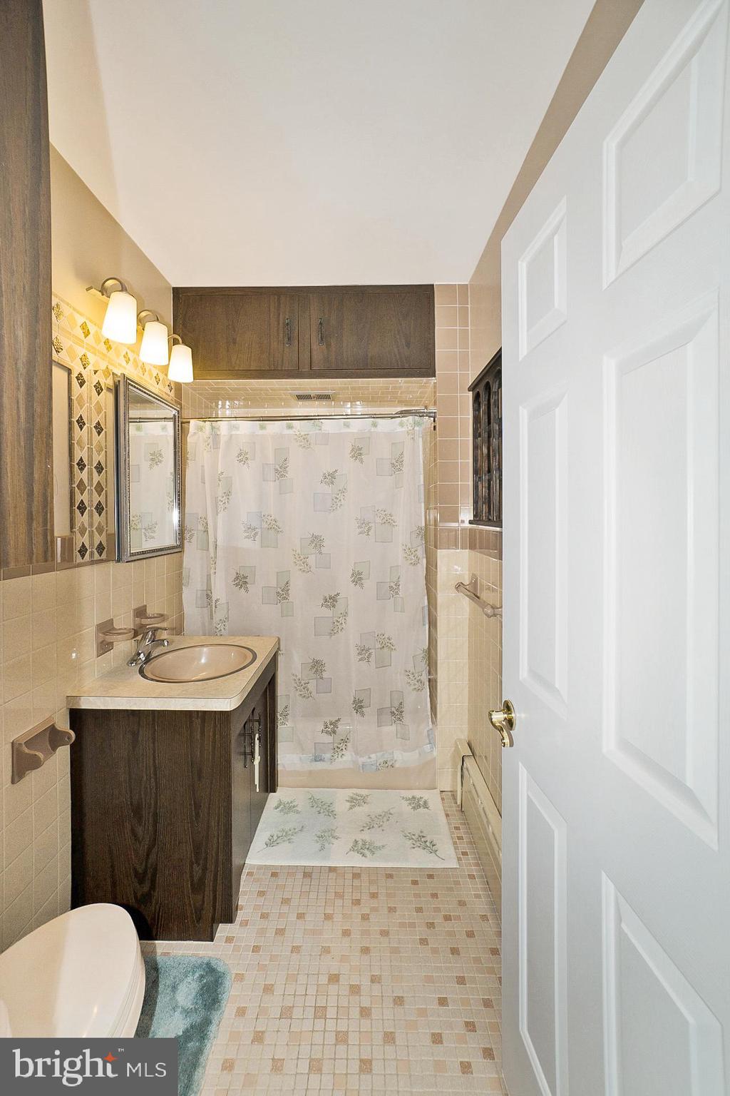 2627 Welshtown Road Slatington, PA 18080 - Photo 19 of 32 a bathroom with a sink a toilet a mirror and shower