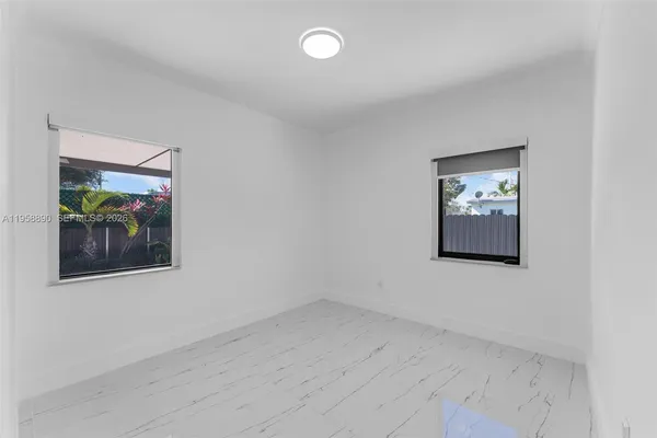 an empty room with a painting on the wall