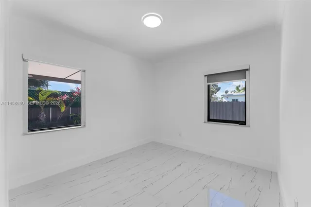 an empty room with a painting on the wall