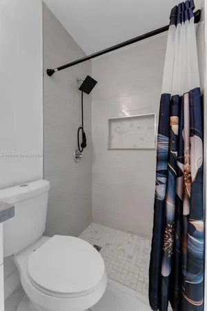 a bathroom with a toilet and a shower