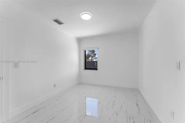 an empty room with a bench