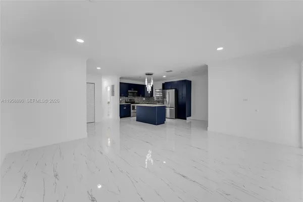 a view of a kitchen with a sink and a refrigerator