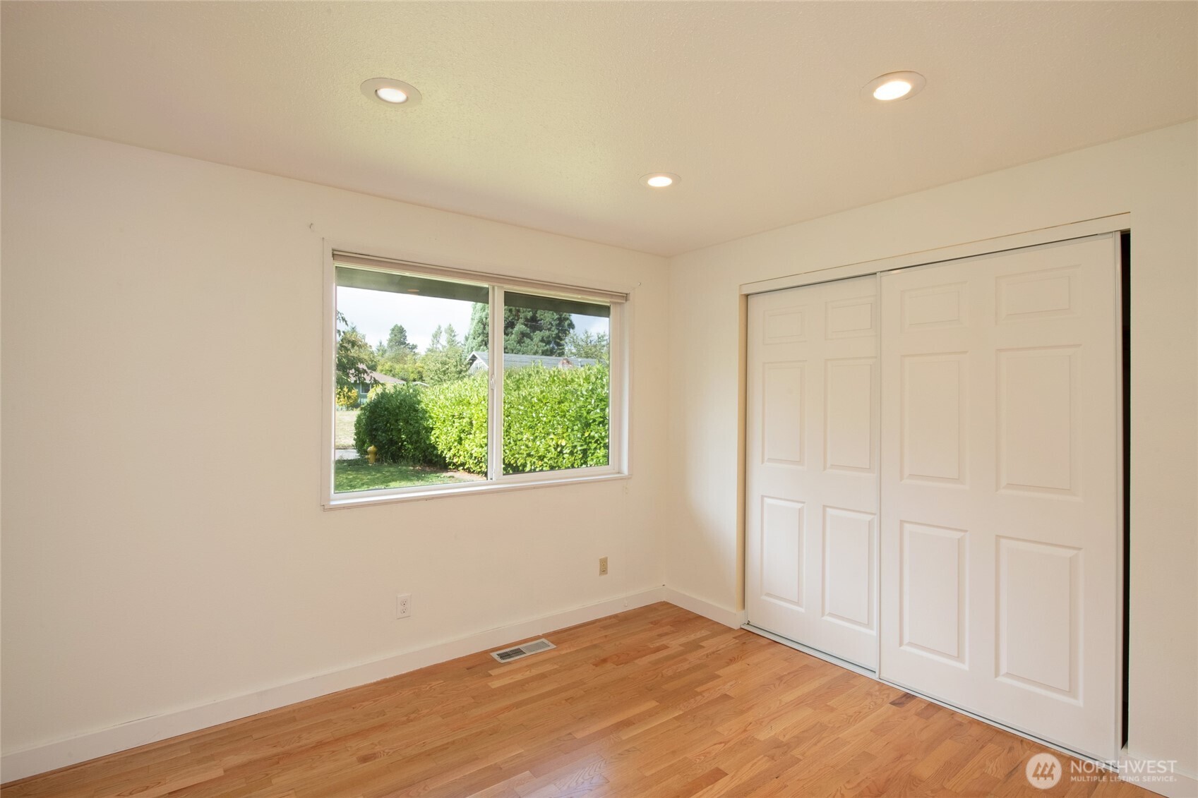 1919 Clovercrest Street Enumclaw, WA 98022 - Photo 18 of 30 an empty room with wooden floor and windows