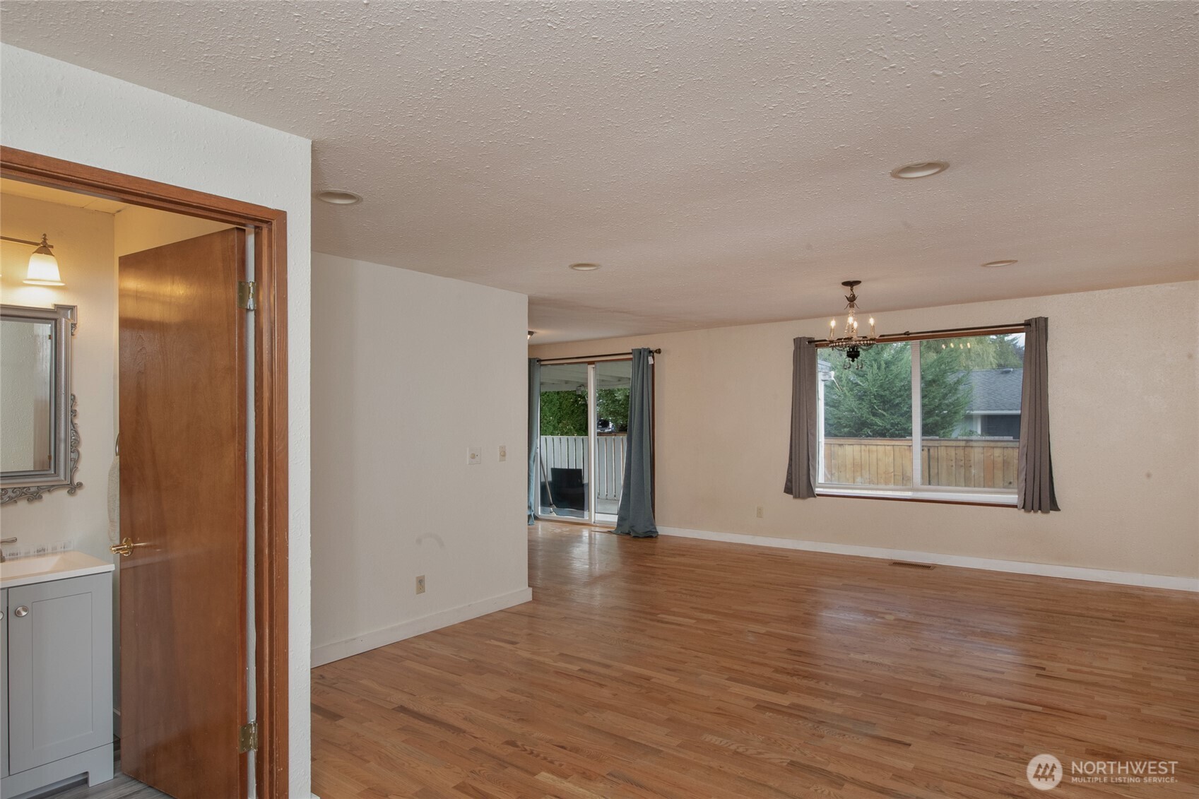 1919 Clovercrest Street Enumclaw, WA 98022 - Photo 22 of 30 a view of an empty room with wooden floor and a window