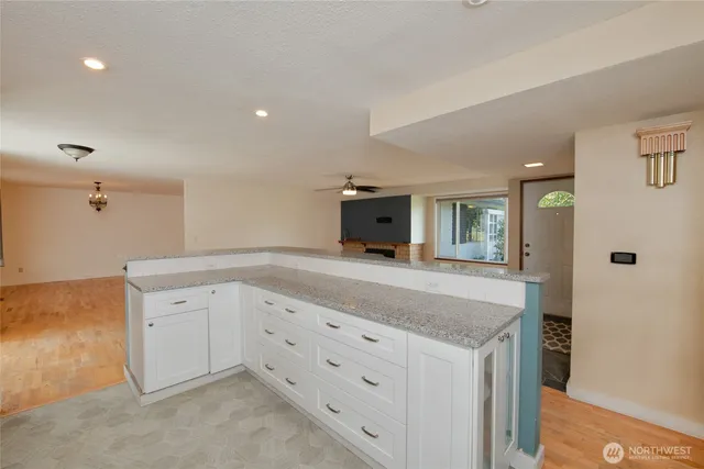 a large kitchen with stainless steel appliances granite countertop a stove a sink and a refrigerator