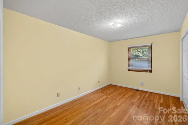 a view of a room with wooden floor and wall painting