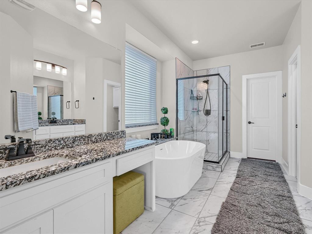 6221 Muller Creek Drive Pilot Point, TX 76258 - Photo 20 of 40 a spacious bathroom with a granite countertop tub sink and mirror