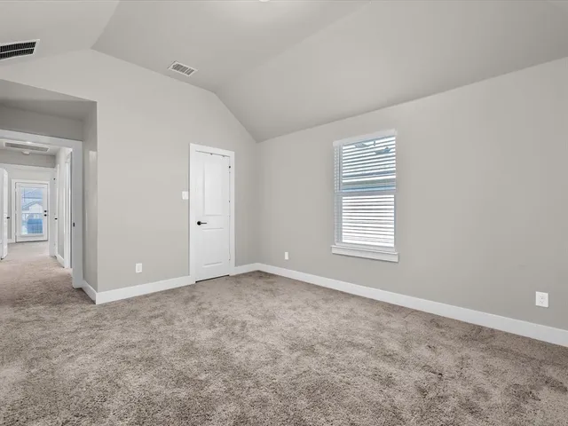 an empty room with windows and closet