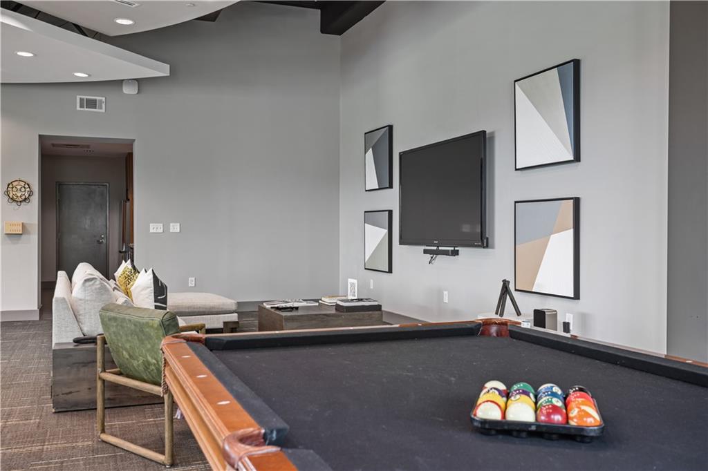 250 Pharr Road Northeast, Unit 606 Atlanta, GA 30305 - Photo 21 of 31 a living room with a flat screen tv and a couch