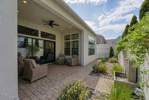 a view of a patio with couches table and chairs and potted plants