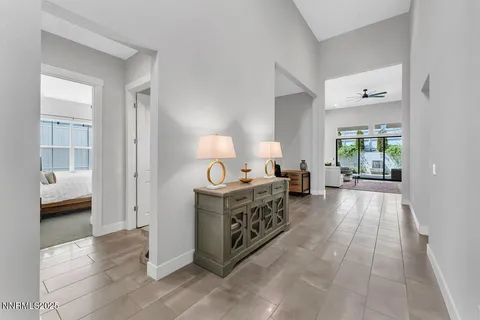 a hall with kitchen island hardwood floor and a window