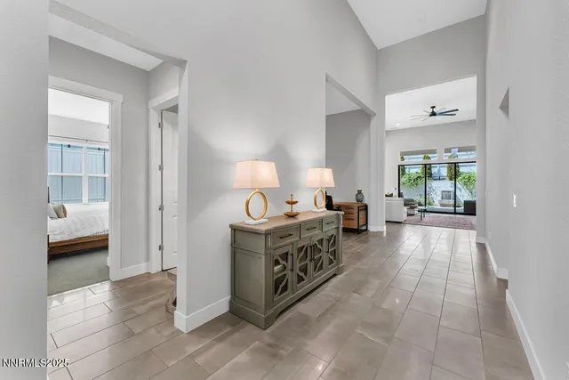 a hall with kitchen island hardwood floor and a window