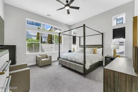 a bedroom with a bed couch and window