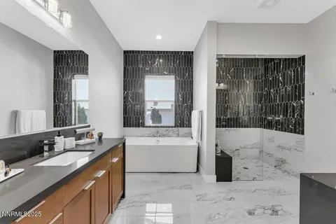 a spacious bathroom with a bathtub and a sink