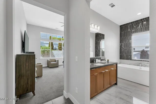 a bathroom with a granite countertop sink and a mirror