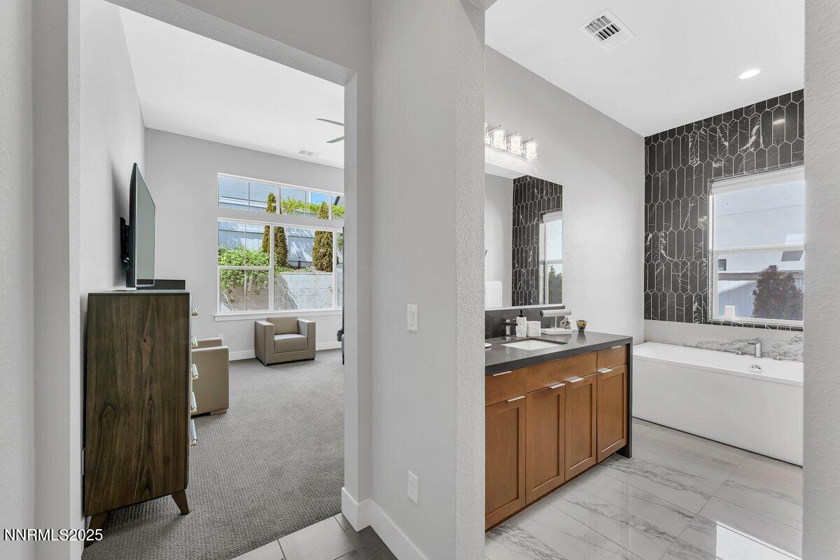 6119 South Pleasant Oak Trail Reno, NV 89511 - Photo 22 of 44 a bathroom with a granite countertop sink and a mirror