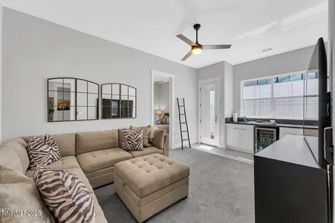 a living room with furniture and kitchen view