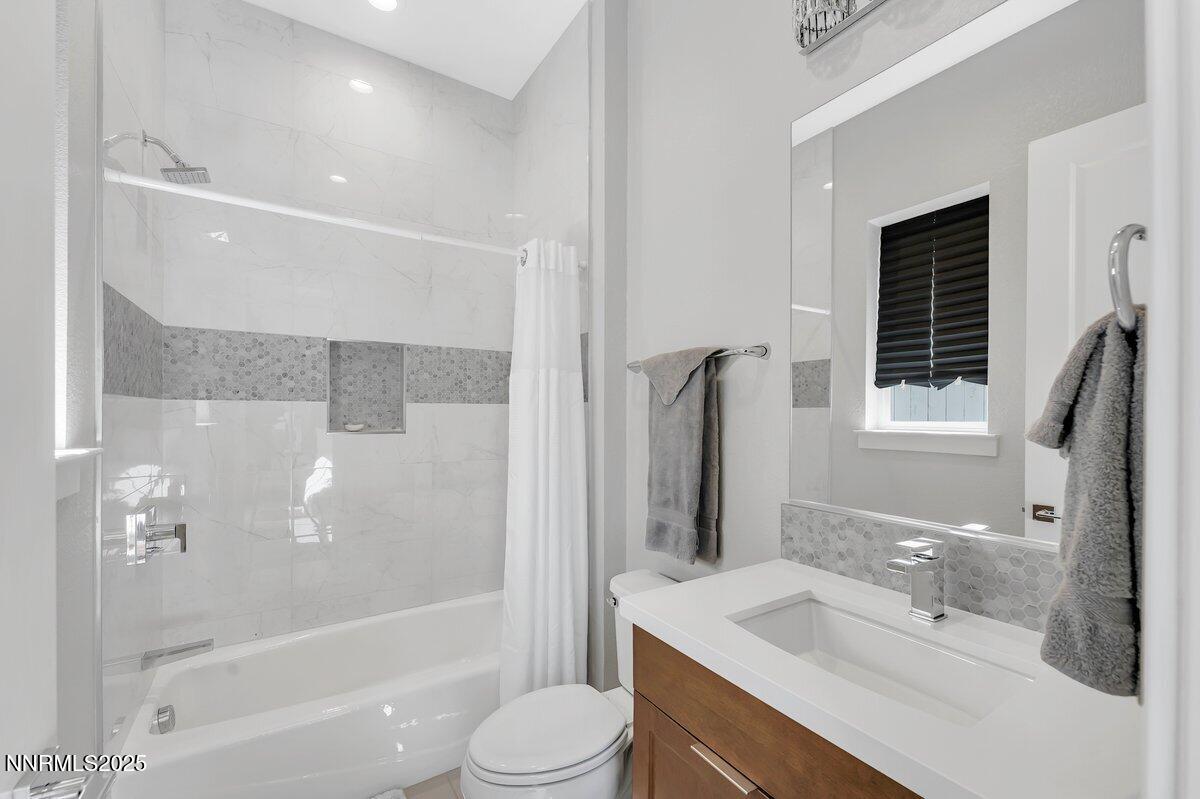 6119 South Pleasant Oak Trail Reno, NV 89511 - Photo 26 of 44 a bathroom with a sink a toilet and shower