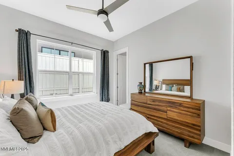 a bedroom with a bed and a large window