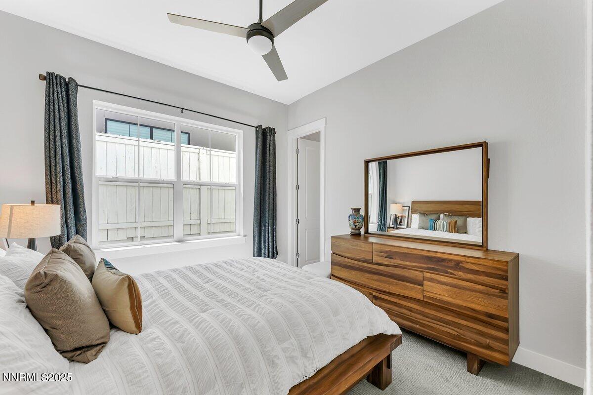 6119 South Pleasant Oak Trail Reno, NV 89511 - Photo 27 of 44 a bedroom with a bed and a large window