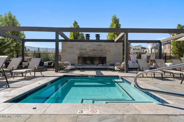 a view of a swimming pool with outdoor seating