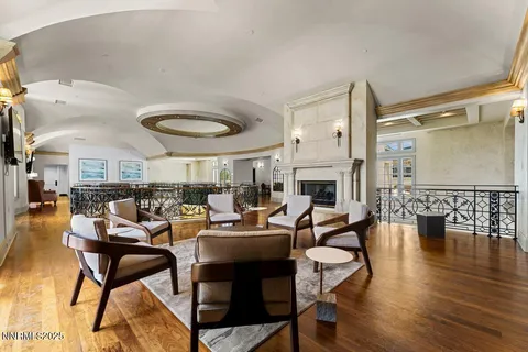 a living room with fireplace furniture and a large window