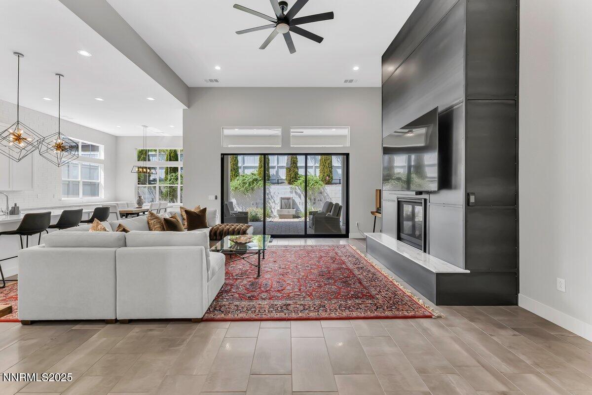 6119 South Pleasant Oak Trail Reno, NV 89511 - Photo 6 of 44 a living room with furniture and a rug