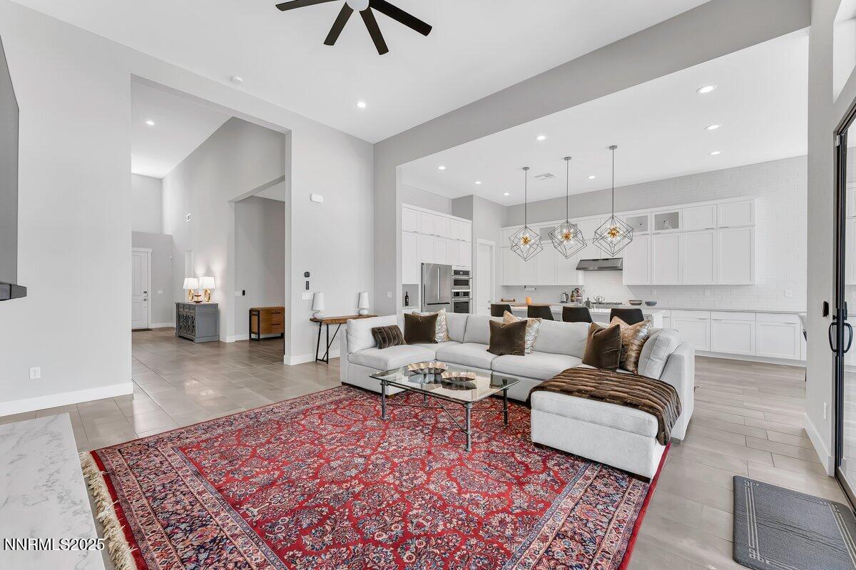 6119 South Pleasant Oak Trail Reno, NV 89511 - Photo 7 of 44 a living room with furniture and a rug