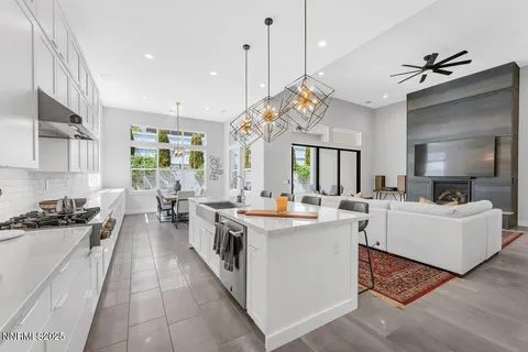 a large kitchen with kitchen island a large counter space a sink appliances and cabinets