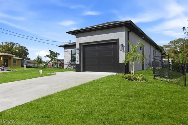 a view of a kitchen with refrigerator and a sink