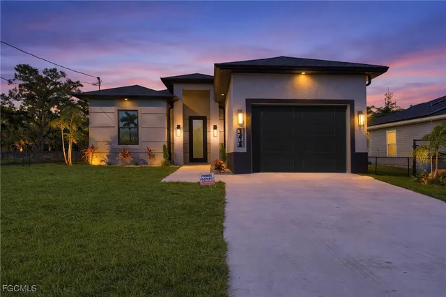 a view of a kitchen with a sink and a refrigerator