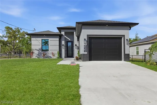 a kitchen with stainless steel appliances a sink a stove a refrigerator and cabinets