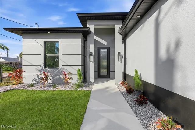 a kitchen with stainless steel appliances a stove a sink a refrigerator a microwave and cabinets