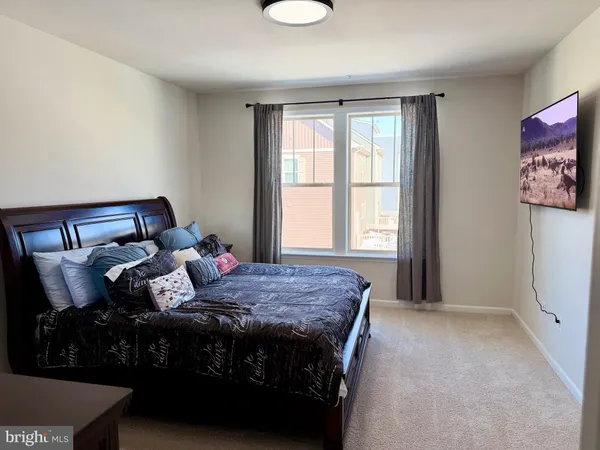 a bedroom with a bed and window