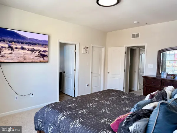 a bedroom with a bed and a couch