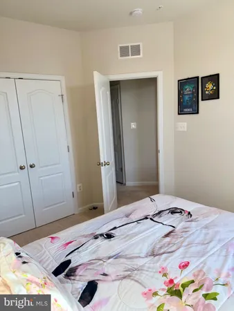 a bedroom with a bed and a area