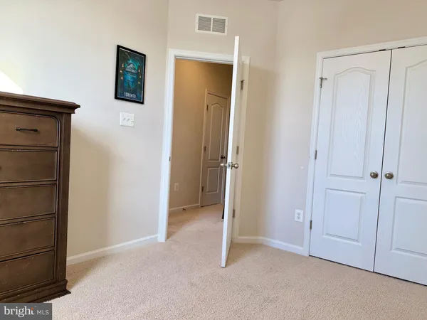 a view of an empty room and closet area